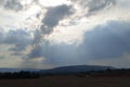 Heavenly eye. A pillar of sunrays through thunder clouds