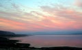 Light colors at sunset over the sea: pink clouds and yellow blue sky Royalty Free Stock Photo