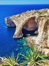 Heavenly resting place on the sea beach sand with large boulders. Legendary bridge lovers. Natural stone arch and sea caves and Royalty Free Stock Photo