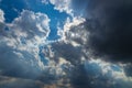 Heavenly Sun Rays Through Dark Clouds Against The Blue Sky. Royalty Free Stock Photo
