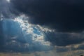 Heavenly Sun Rays Through Dark Clouds Against The Blue Sky. Royalty Free Stock Photo