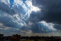 Heavenly Sun Rays Through Dark Clouds Against The Blue Sky. Royalty Free Stock Photo