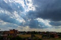 Heavenly Sun Rays Through Dark Clouds Against The Blue Sky. Royalty Free Stock Photo