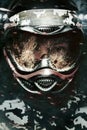 Heavily armed masked paintball soldier on post apocalyptic background. Ad concept. Royalty Free Stock Photo