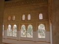 Heavily decorated wall with horseshoe windows of NAsrid Palace , Alhambra, Spain