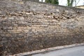 Heavily eroded marl wall by the road. rain frosts and heavy rains damage the stone. the wall needs to be repaired