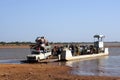 A heavily-loaded truck drives off the cross-river ferry near Djenne, Mali
