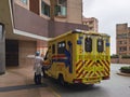 15 2 2022 Heavily protected and equipped medical staff and Ambulance waiting to pick up a covid-19 or omicron patient near a Royalty Free Stock Photo