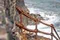 Heavily rusted iron chain links - part of fencing along the sea front in Playa Blanca, Lanzarote, Spain Royalty Free Stock Photo