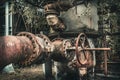 Heavily rusted pipes and pipes with peeling paint of an old disused derelict factory