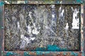 A heavily weathered and textured noticeboard