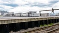 Heavy aluminum bars lying on each other on stack in the square of an aluminum smelter.