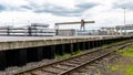 Heavy aluminum bars lying on each other on stack in the square of an aluminum smelter.