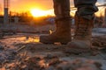 heavy boots trudging through unfinished site in sunset light Royalty Free Stock Photo