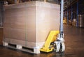 Heavy box on pallet rack with hand pallet truck at the warehouse storage. cargo shipment boxes, manufacturing and warehousing. Royalty Free Stock Photo