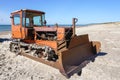 Heavy bulldozer as fishing boat puller on the sand at the seashore Royalty Free Stock Photo
