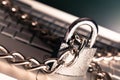 Heavy chain with a padlock around a laptop, close Royalty Free Stock Photo