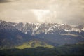 Heavy clouds over the Bucegi mountains in Romania during a spring day, as seen from the hills of Pestera village in Transylvania Royalty Free Stock Photo