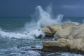 Heavy clouds with stormy waves beating against rocks and cliffs