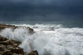 Heavy clouds with stormy waves beating against rocks and cliffs