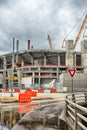 Heavy construction cranes erecting concrete building