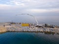 Heavy construction equipment is building a breakwater. Pouring concrete on a pier under construction in the sea. Royalty Free Stock Photo