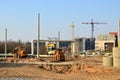 Heavy construction equipment and earthmoving excavators working on a construction site in the city. Royalty Free Stock Photo