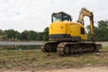 Heavy construction equipment. Yellow excavator on the construction site