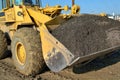 Heavy construction loader moving gravel