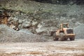 Heavy construction machinery in open pit ore mine - wheel loader transports gravel at sorting plant Royalty Free Stock Photo