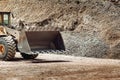 Heavy construction machinery in open pit ore mine - wheel loader transports gravel at sorting plant Royalty Free Stock Photo