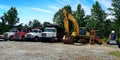 Row of construction vehicles lined up. Dump trucks, excavators, bulldozer