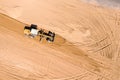 Heavy construction machinery working on road construction site. aerial top view Royalty Free Stock Photo