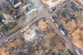 Heavy construction machines clearing out pile of debris of destroyed building after demolition. aerial view