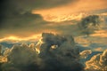 Heavy and dramatic storm cloud formations in colorful summer sky at sunset Royalty Free Stock Photo