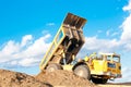 Heavy dump truck unloading soil Royalty Free Stock Photo