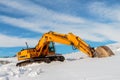 Heavy Duty construction equipment parked at work site and winter. Royalty Free Stock Photo