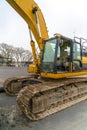 Heavy duty construction vehicle parked on the road Royalty Free Stock Photo