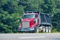 Heavy-Duty Red Dump Truck Merging Onto Main Road