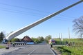 Heavy duty transport of a windmill blade lifted up to avoid obstacles such as a power lines on a narrow country road junction, Royalty Free Stock Photo