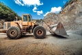 Heavy duty wheel loader excavator working in ore quarry Royalty Free Stock Photo