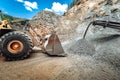 Heavy duty wheel loader excavator working in ore quarry Royalty Free Stock Photo