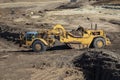 Heavy earthmoving equipment including scapers and motor graders involved in grading operations Royalty Free Stock Photo