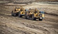 Heavy earthmoving equipment including scapers and motor graders involved in grading operations Royalty Free Stock Photo