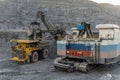 A heavy electric excavator loads ore into a dump truck. Royalty Free Stock Photo