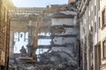 Heavy equipment hydraulic shears arrow dismantle the building, demolition destruction