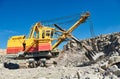 Excavator works with granite or ore at opencast mining