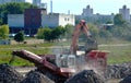 Heavy excavator working in quarry on a background of sunset and blue sky.