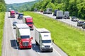 A heavy flow of 18-wheelers peppered with cars and SUVs roll down a Tennessee interstate highway Royalty Free Stock Photo