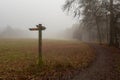 Heavy fog at the crossroads with signposts in the forest. The sign reads: target